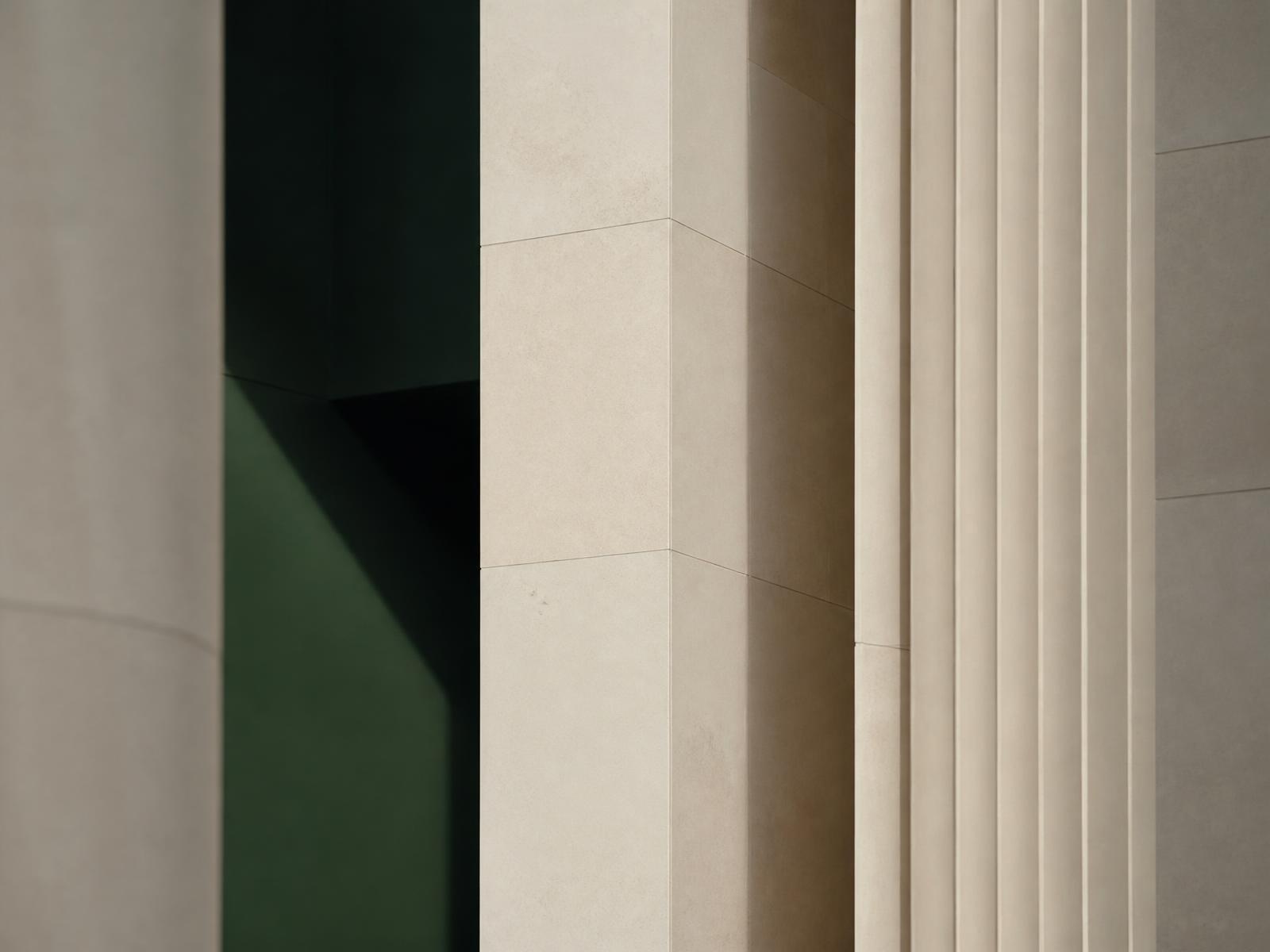 Detail of a modern stone building facade in soft daylight